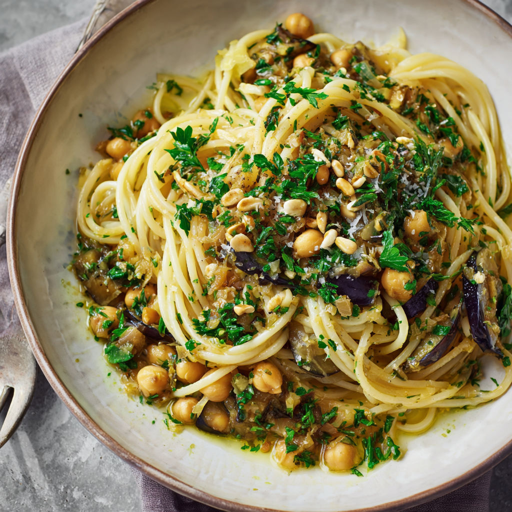 A bowl of pasta with chickpeas and spinach.