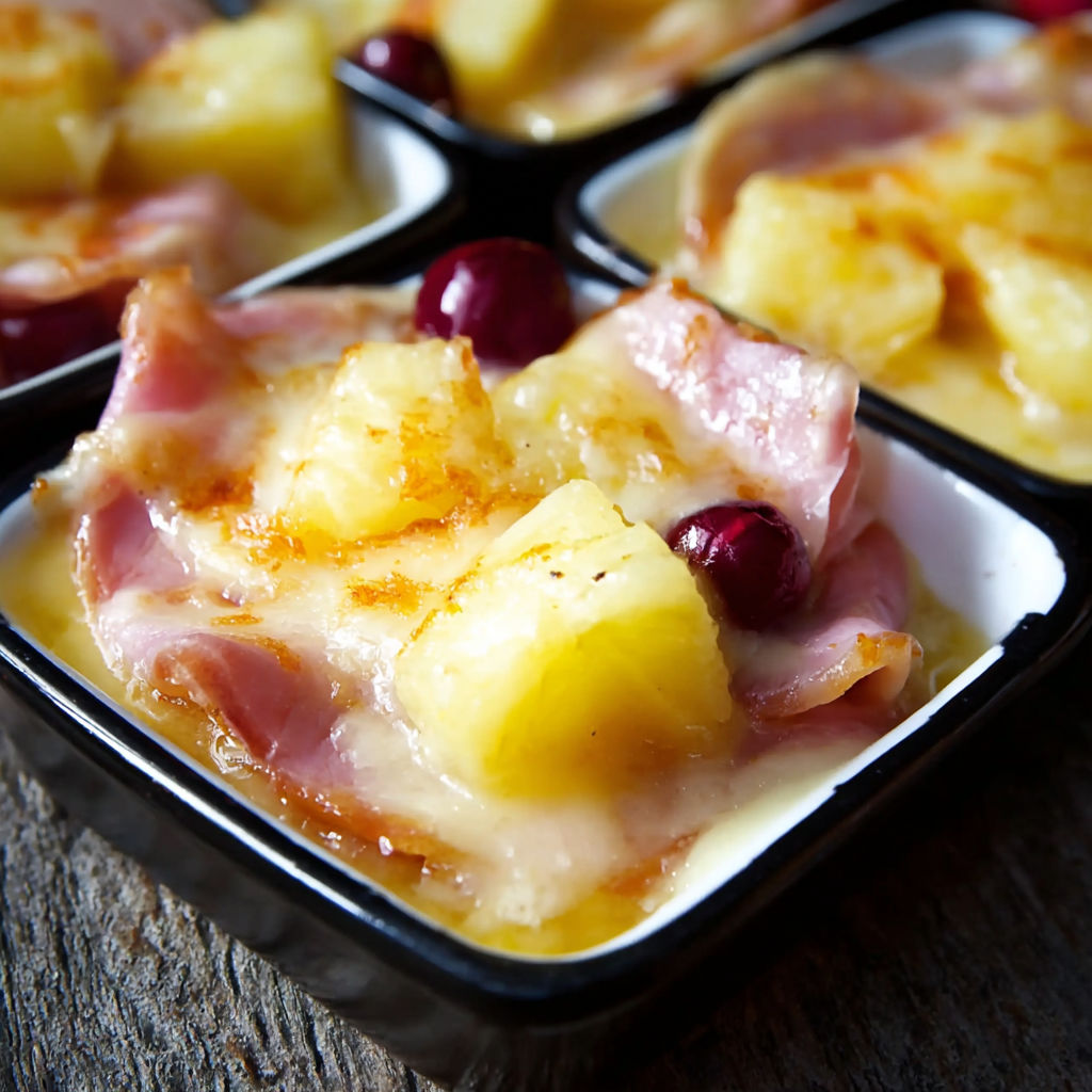 A plate of food with pineapple and ham.