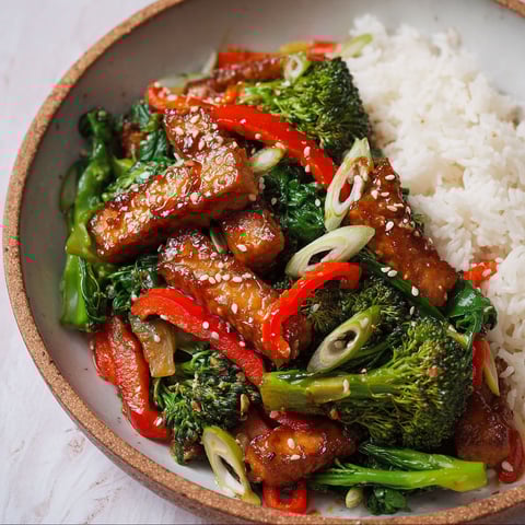 A bowl of stir fry with meat and vegetables.