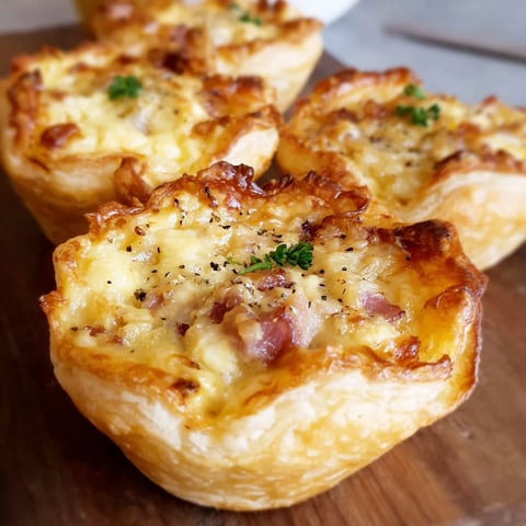 Three muffins with cheese and herbs.