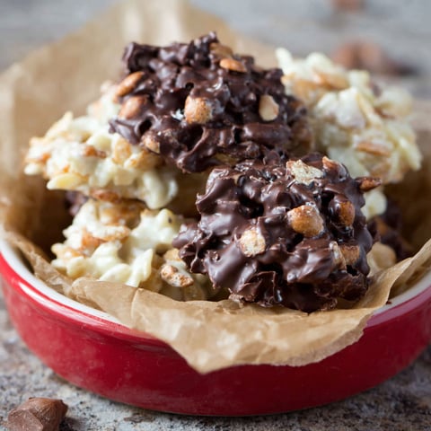 A bowl of chocolate covered nuts.
