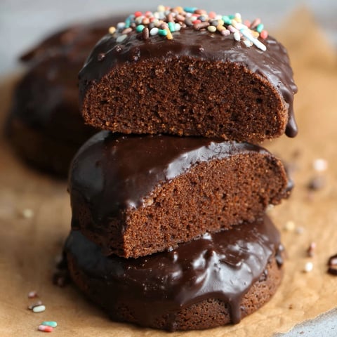Three chocolate cakes stacked on top of each other.